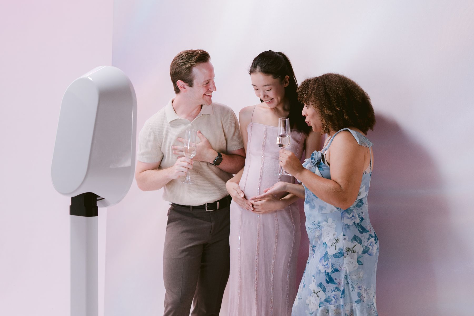 Three guests laughing together at the digital photo booth