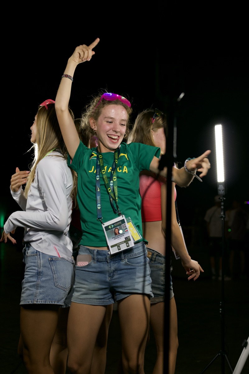 Guest raising an arm while posing on the 360 booth